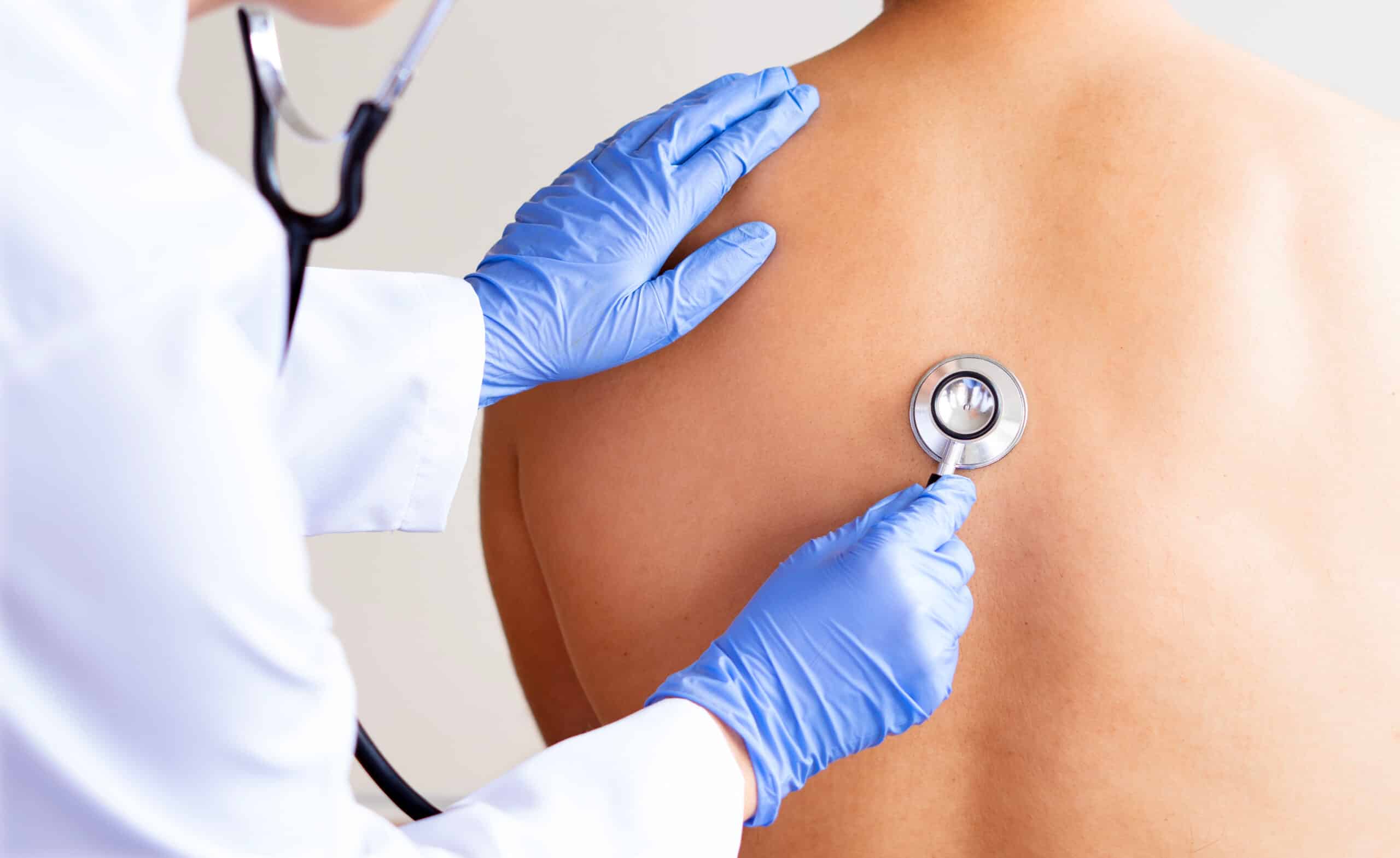 Doctor checking her mature patient's heart during a consultation in a medical center