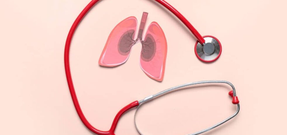 Paper lungs and stethoscope on beige background
